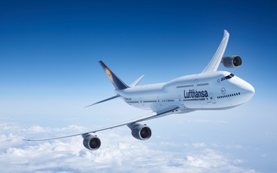 Boeing 747-8 above the fluffy clouds wallpaper