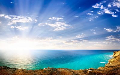 Bright sun shining over the splendid coastline Wallpaper