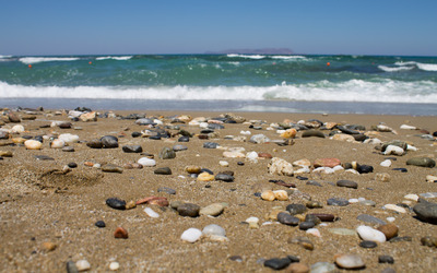 Pebbles on the sandy beach Wallpaper