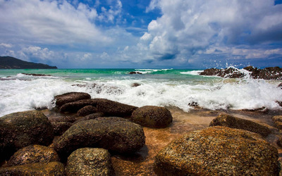 Waves reaching to the rocky beach wallpaper