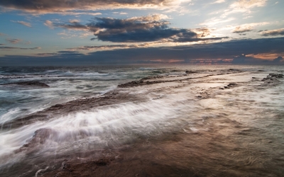 Waves washing the rocky shore wallpaper