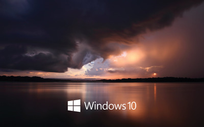 Windows 10 white text logo over the stormy sea wallpaper