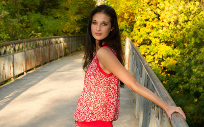 Cute brunette in a summer dress on a bridge wallpaper