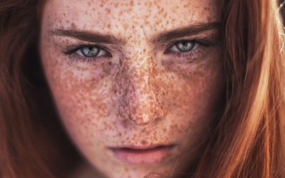 Redhead with freckles and blue eyes wallpaper