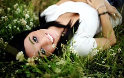 Smiling brunette in the grass wallpaper