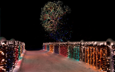 Colorful Christmas lights on the snowy bridge wallpaper