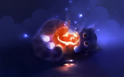 Cute kitten holding a happy Jack-o'-lantern wallpaper
