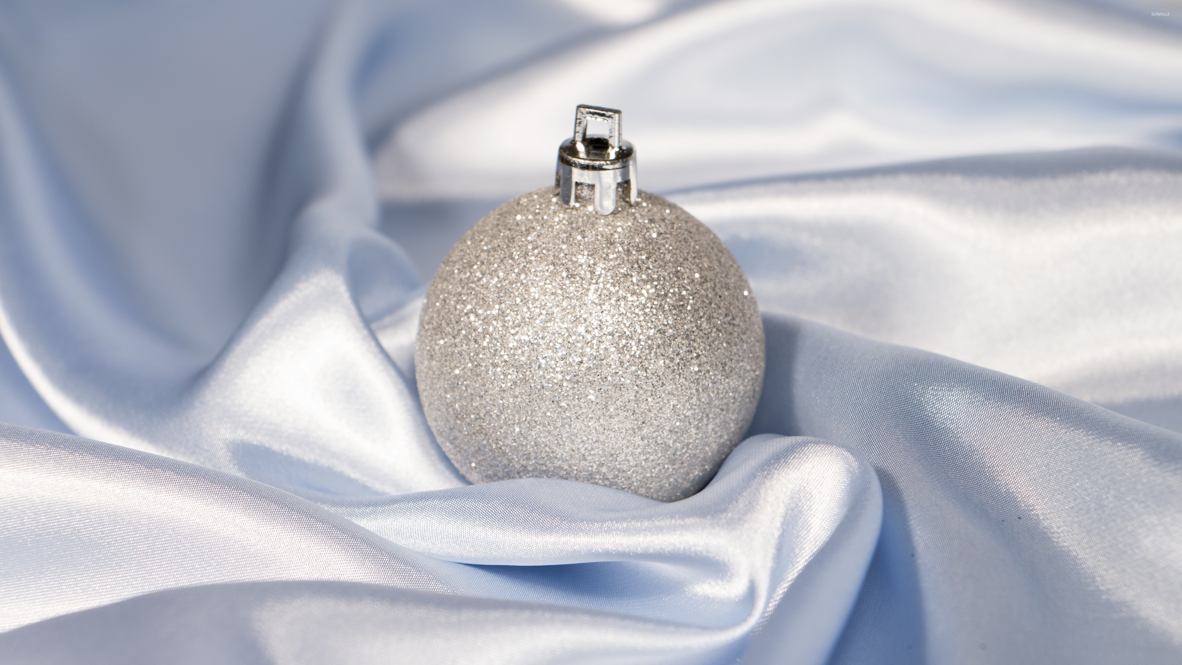 Silver Christmas bauble in silk wallpaper Holiday