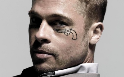 Brad Pitt with a pistol drawn under his eye wallpaper