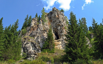 Cave in the rocky peak Wallpaper