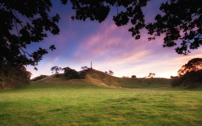 Monument on the hill reaching to the sunset sky wallpaper