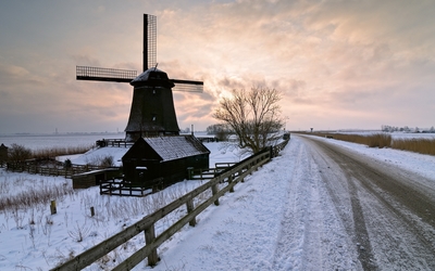 Old windmill on a snowy field Wallpaper