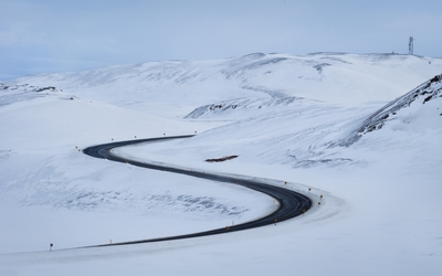 Road through the snowy hills wallpaper
