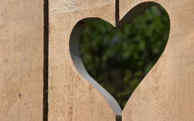 Wooden panels with a heart shaped hole wallpaper