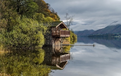 Stone house reflecting in the lake Wallpaper