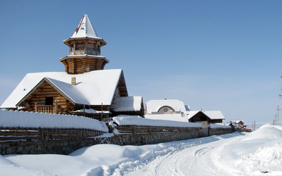 Wooden church covered in snow wallpaper